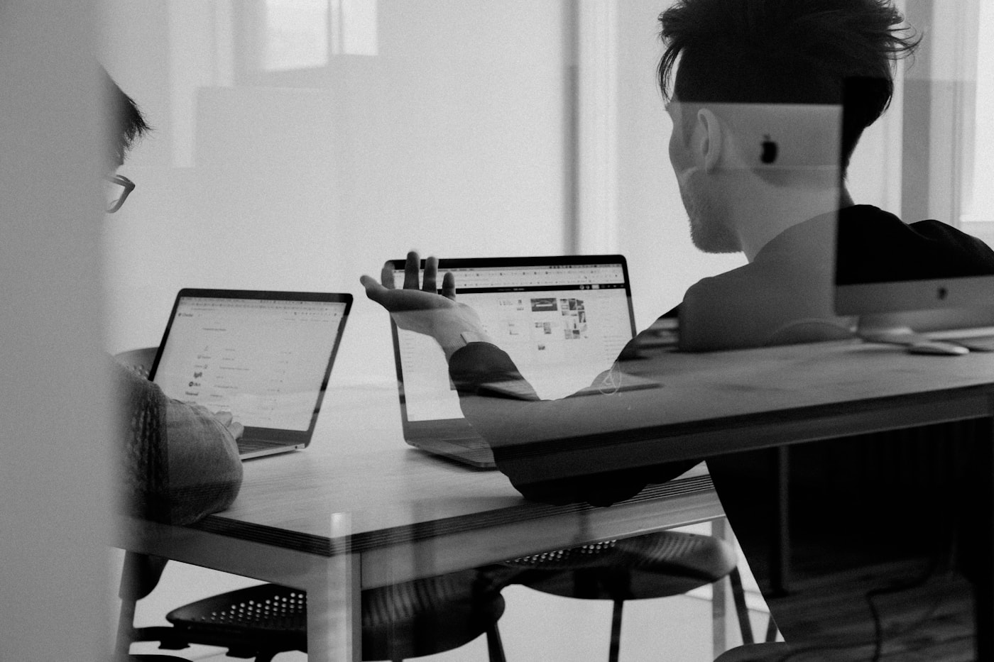 Content team collaborating around a laptop